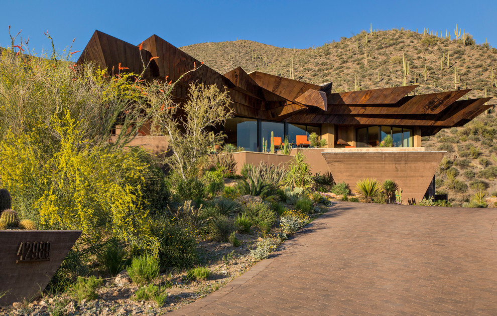 Inspiration for a contemporary brown one-story exterior home remodel in Phoenix