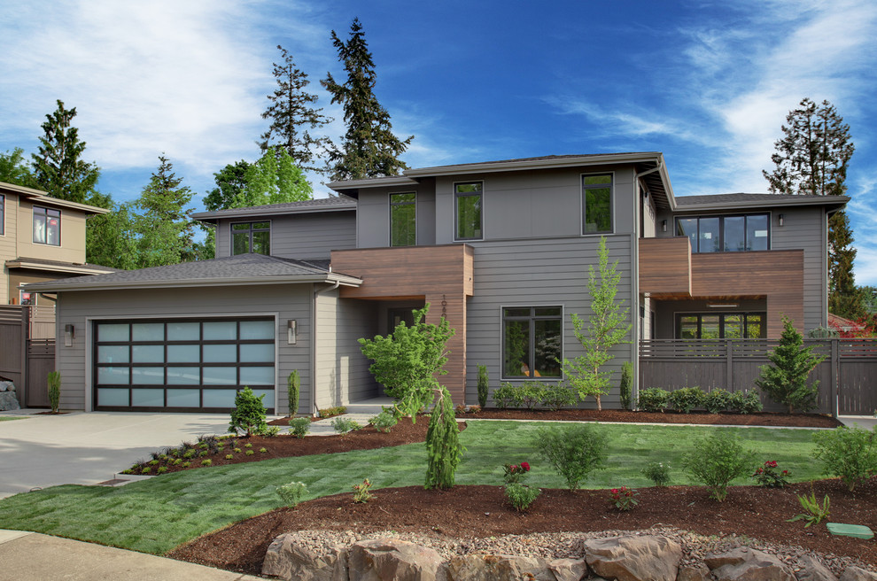 Photo of a gey contemporary two floor house exterior in Seattle with mixed cladding and a hip roof.