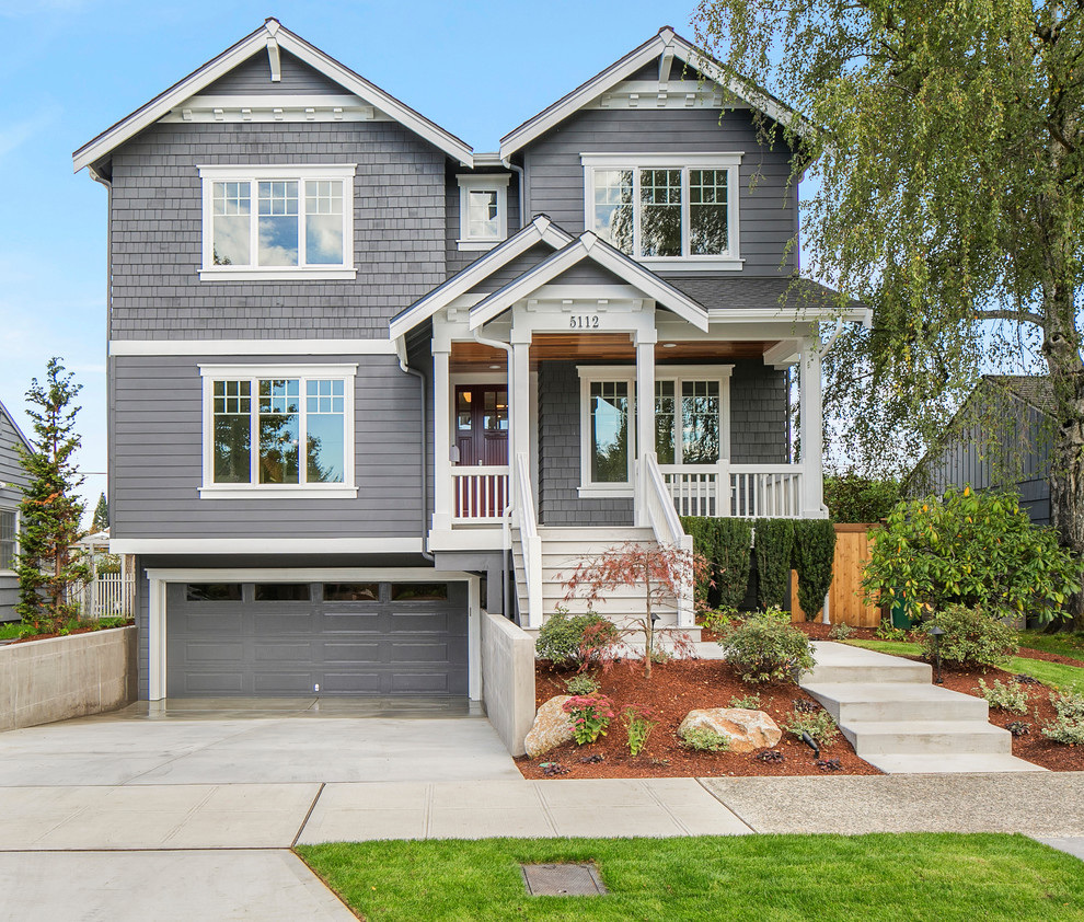 Inspiration for a craftsman gray three-story wood gable roof remodel in Seattle