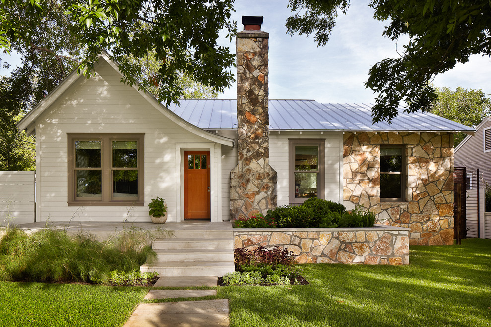 Design ideas for a small traditional bungalow house exterior in Austin with wood cladding.