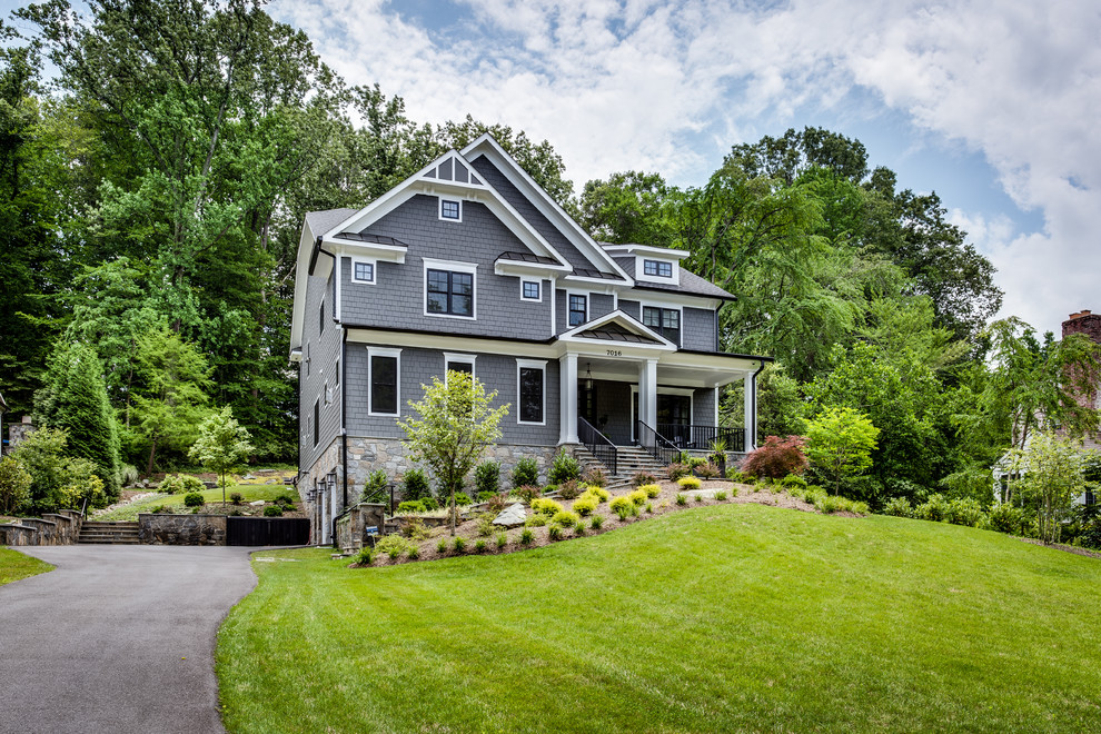 This is an example of a large and gey classic house exterior in DC Metro with three floors, concrete fibreboard cladding and a half-hip roof.