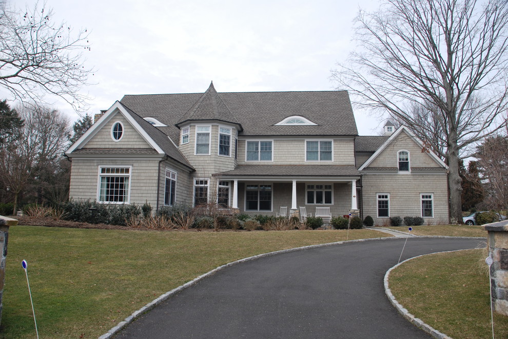 Large elegant gray two-story wood gable roof photo in Other