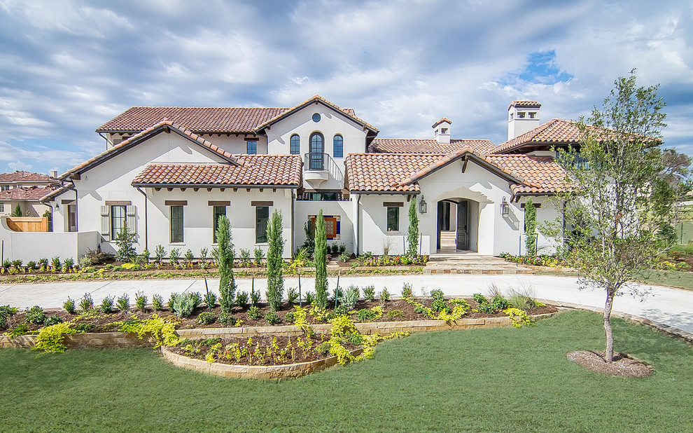 Large tuscan white two-story stucco gable roof photo in Dallas