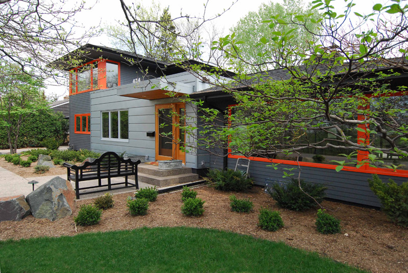 Medium sized and gey contemporary two floor house exterior in Minneapolis with mixed cladding and a hip roof.