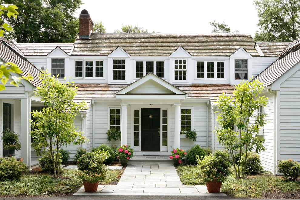 Inspiration for a huge timeless white two-story wood exterior home remodel in Other with a shingle roof