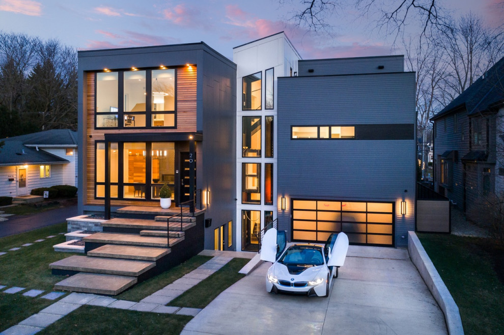 Imagen de fachada de casa gris minimalista grande de dos plantas con revestimientos combinados, tejado de un solo tendido y tejado de metal