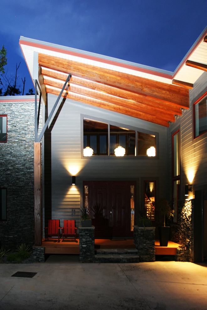 Photo of a large and gey modern house exterior in Atlanta with three floors, mixed cladding and a lean-to roof.