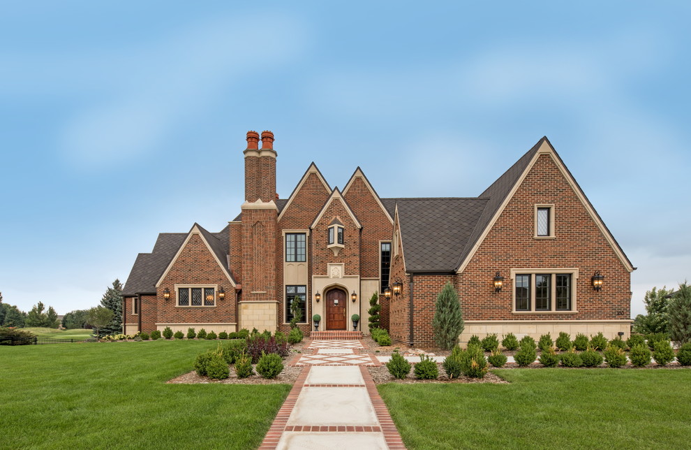 Traditional red two-story brick exterior home idea in Other