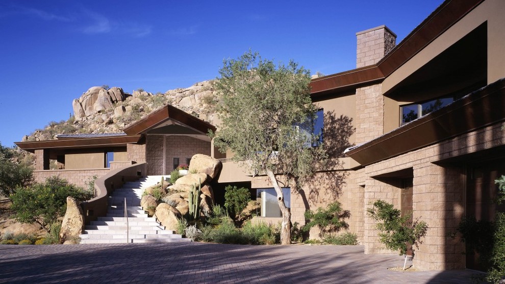 Contemporary beige three-story adobe exterior home idea in Phoenix