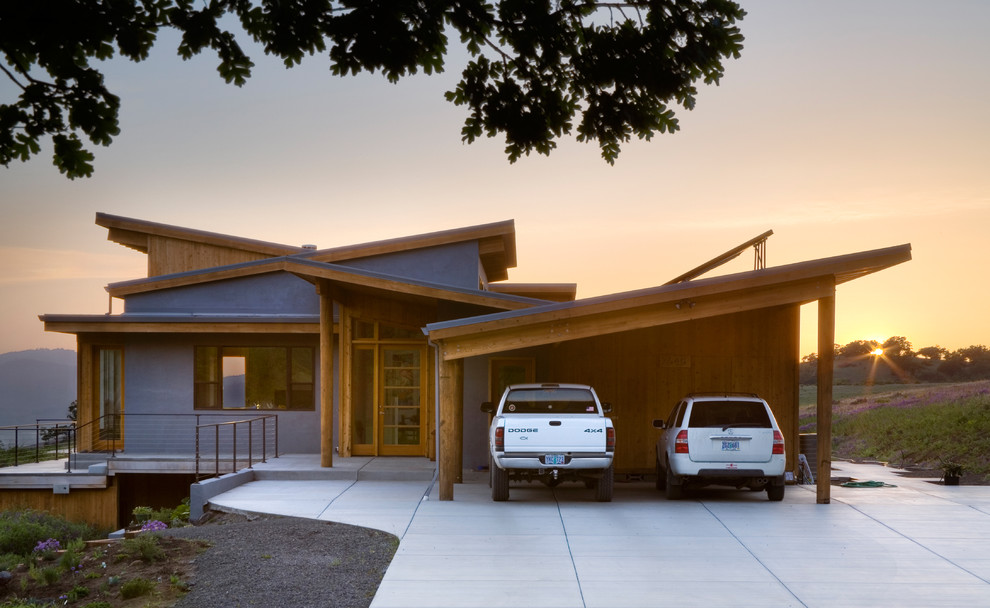 Exemple d'une grande façade de maison multicolore tendance de plain-pied avec un revêtement mixte, un toit en appentis et un toit en métal.