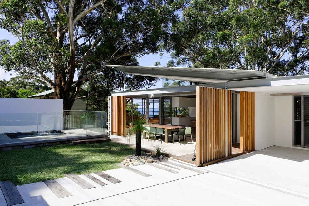 Mid-sized trendy brown two-story wood exterior home photo in Sydney with a metal roof