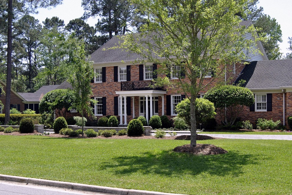 Inspiration for a large timeless red three-story brick exterior home remodel in Atlanta with a shingle roof