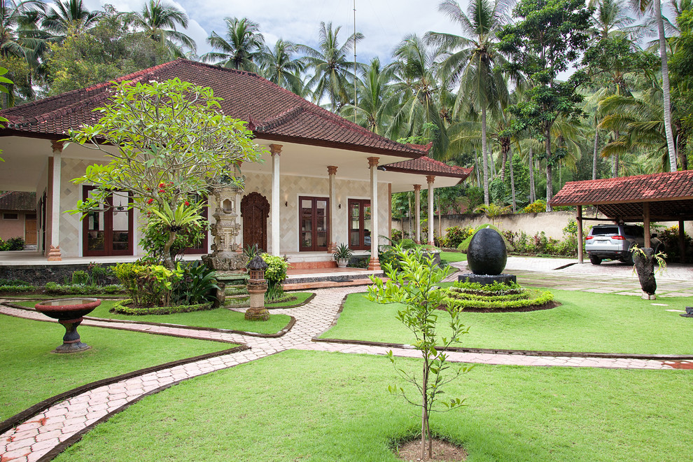 This is an example of a white world-inspired bungalow house exterior in Other.
