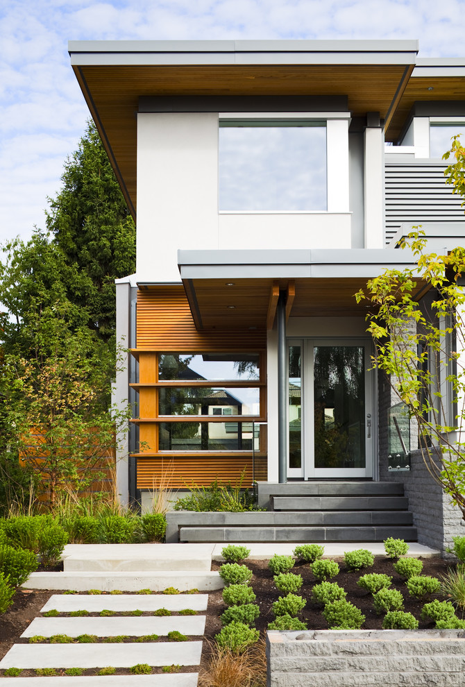 This is an example of a contemporary house exterior in Vancouver with wood cladding.