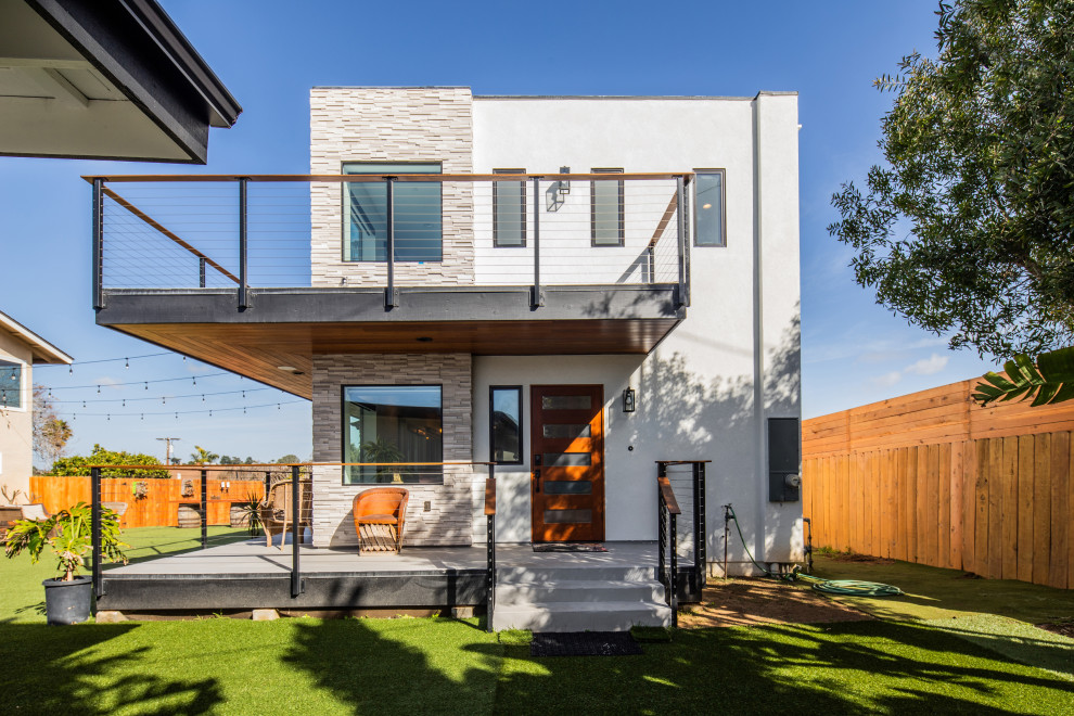 Example of a large zen white two-story brick exterior home design in San Diego