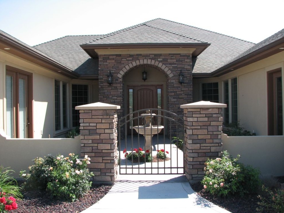 Mid-sized transitional beige one-story stucco house exterior idea in Boise with a hip roof and a shingle roof