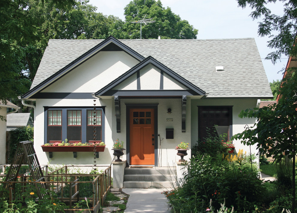 This is an example of a small traditional bungalow house exterior in Minneapolis with a pitched roof.