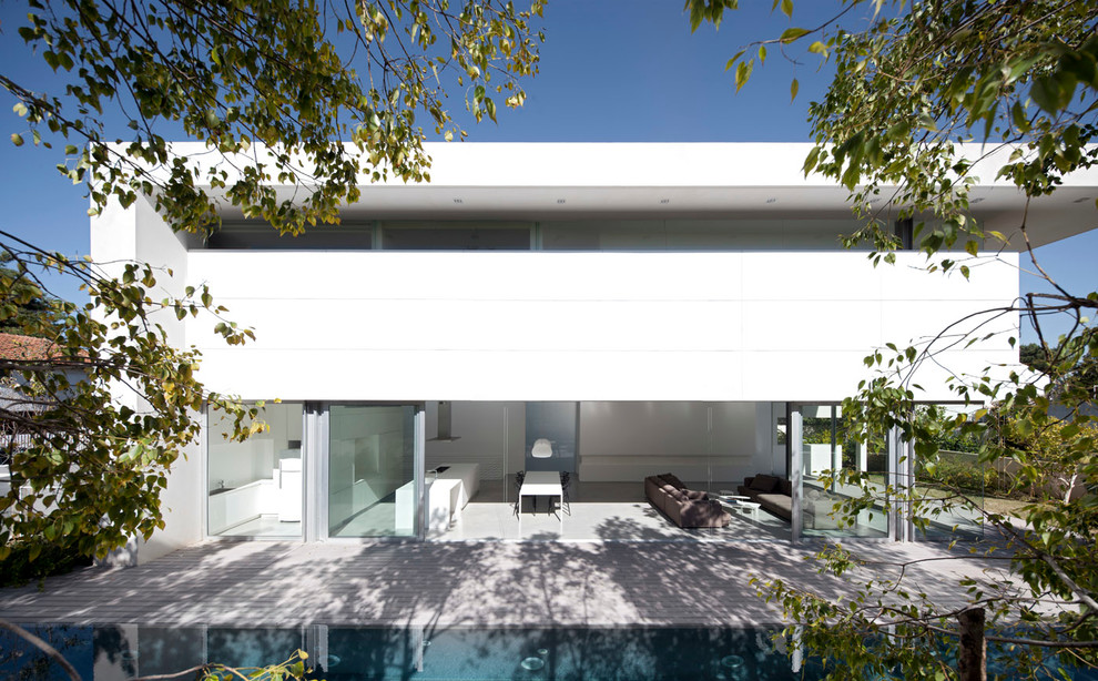 This is an example of a medium sized and white modern two floor house exterior in San Francisco.