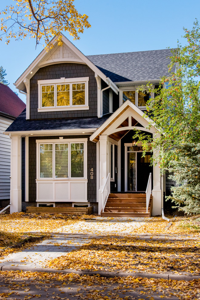 Example of a transitional blue two-story mixed siding exterior home design in Other with a shingle roof