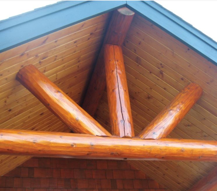 Réalisation d'une grande façade de maison marron chalet en bois avec un toit à deux pans et un toit en shingle.