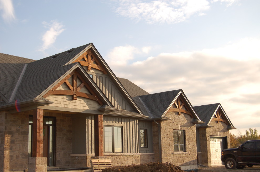 Mid-sized mountain style brown two-story mixed siding gable roof photo in Toronto