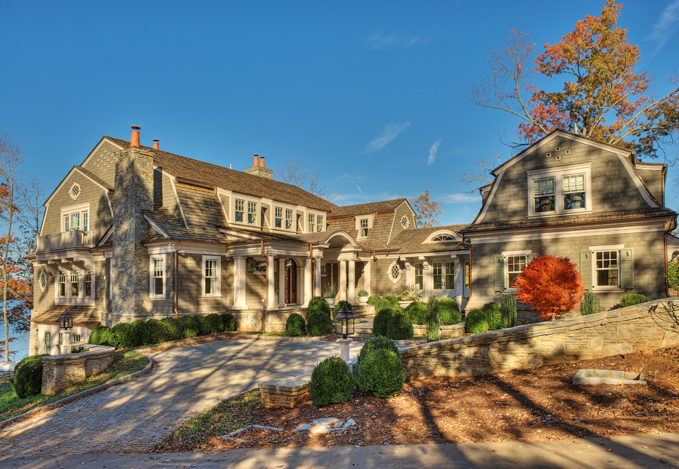 Large elegant gray two-story wood house exterior photo in Other with a gambrel roof and a shingle roof