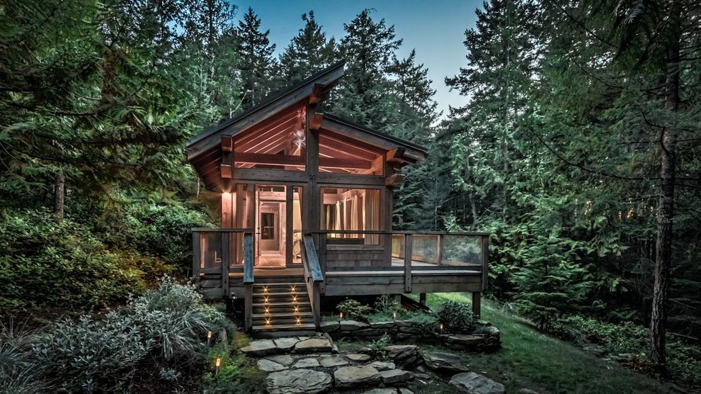 Photo of a small rustic bungalow house exterior in Vancouver with a lean-to roof.