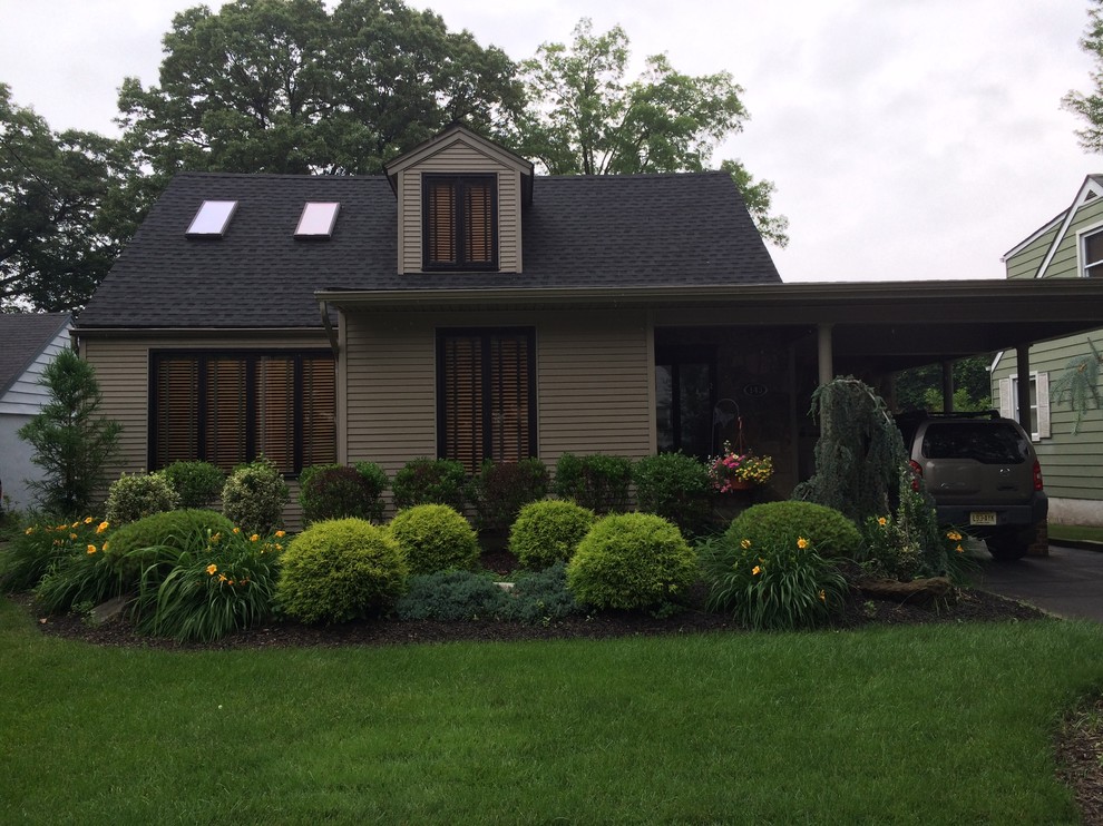 Foto de fachada marrón clásica pequeña de dos plantas con revestimiento de vinilo y tejado a dos aguas