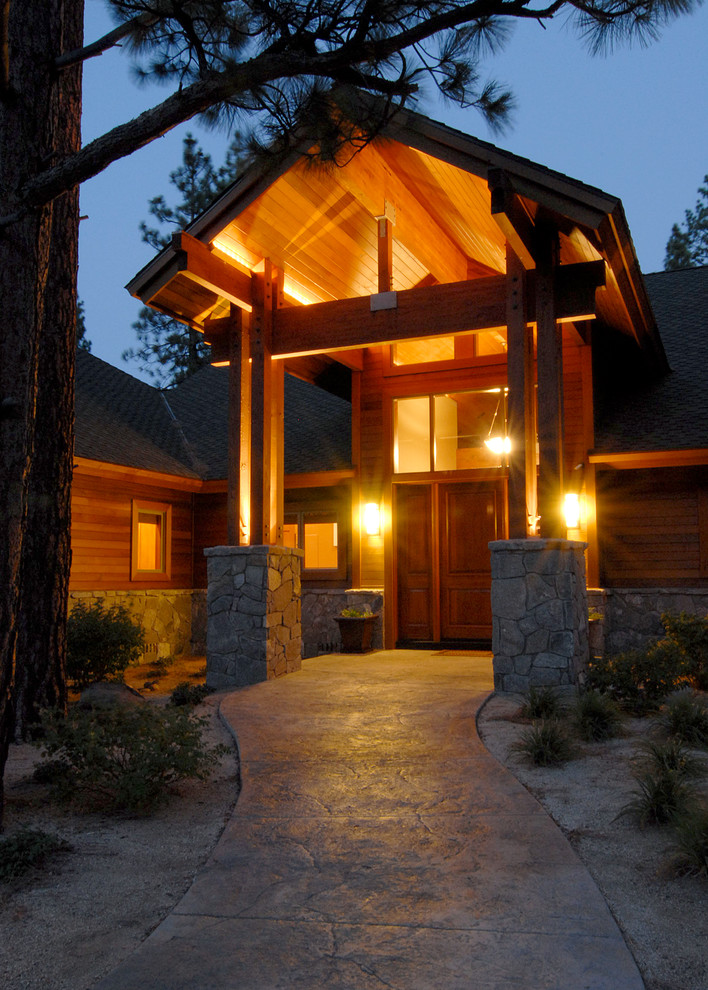 Example of a mid-sized mountain style brown one-story mixed siding exterior home design in Other with a shingle roof