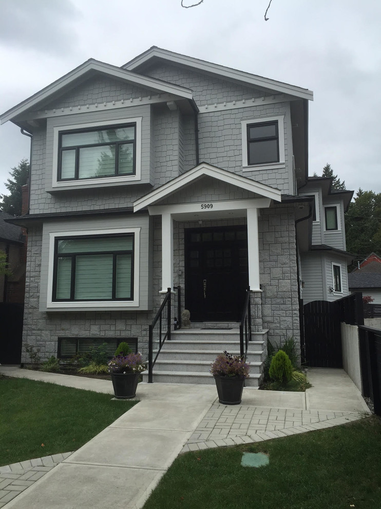 Mid-sized contemporary gray two-story mixed siding exterior home idea in Vancouver with a tile roof