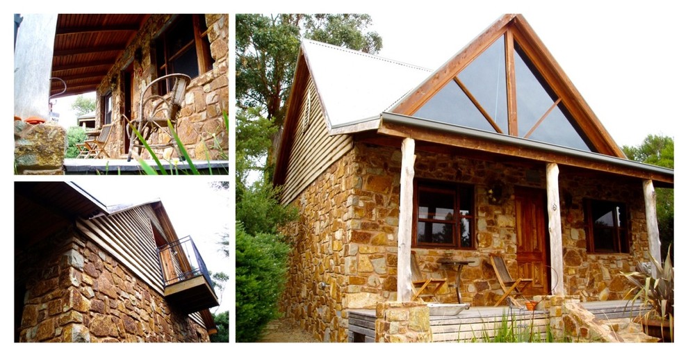 Immagine della villa contemporanea con rivestimento in pietra e tetto a capanna