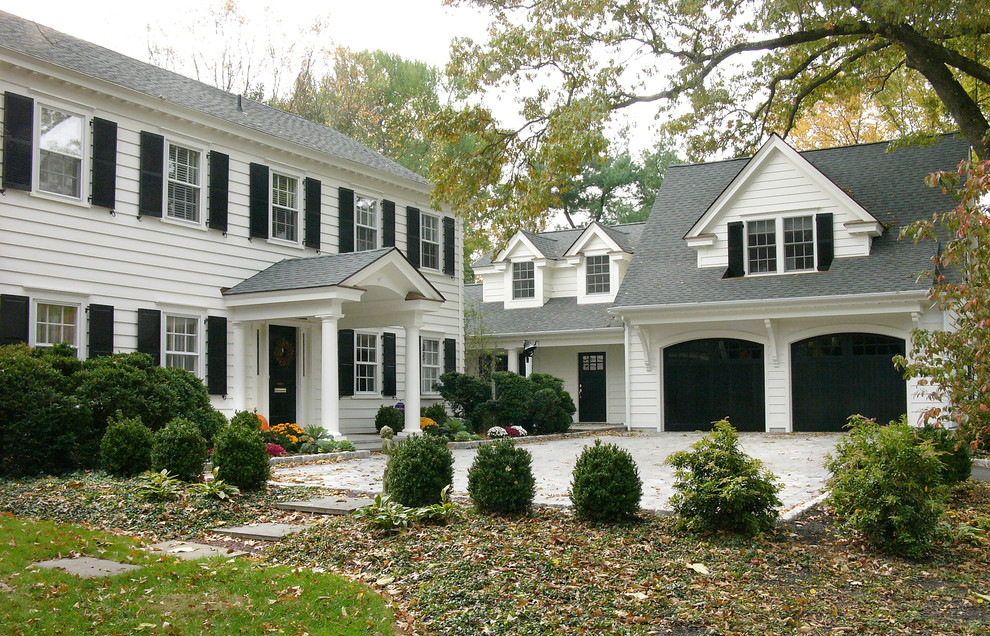 Inspiration for a huge timeless white two-story wood exterior home remodel in Other with a shingle roof