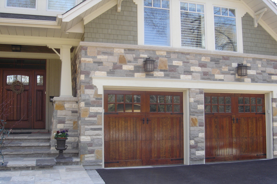This is an example of a large and beige two floor house exterior in Toronto with stone cladding.
