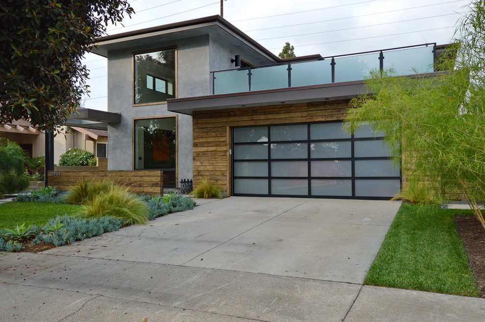Mid-sized minimalist gray two-story mixed siding flat roof photo in Orange County