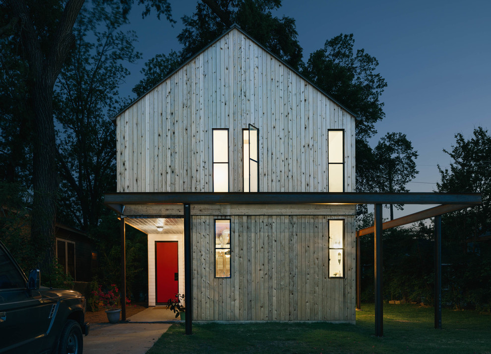 Medium sized and beige contemporary two floor house exterior in Austin with wood cladding and a pitched roof.