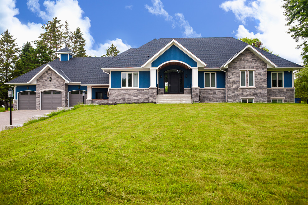 Exemple d'une grande façade de maison bleue chic de plain-pied avec un revêtement mixte, un toit à quatre pans et un toit en shingle.