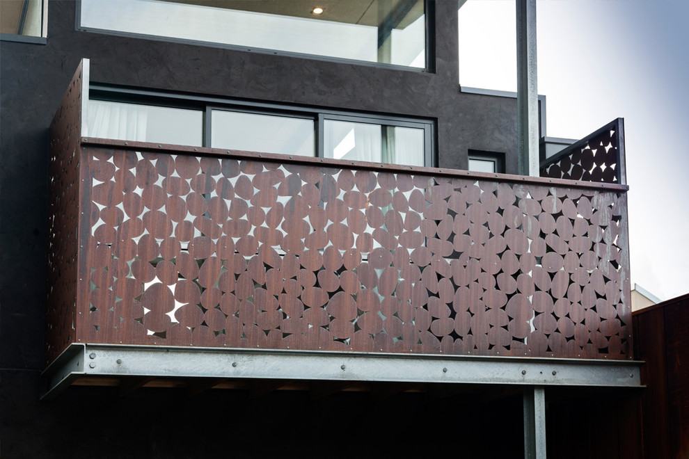 Large and black modern two floor house exterior in Melbourne with metal cladding.