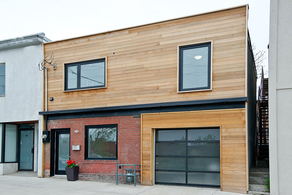 This is an example of a contemporary house exterior in Toronto with wood cladding.