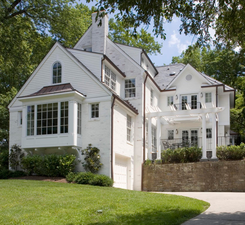 Huge elegant white three-story brick house exterior photo in DC Metro with a shingle roof