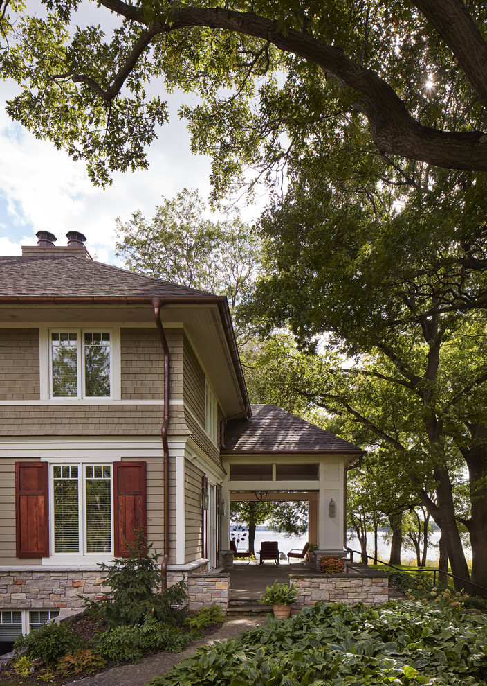 Example of a large transitional gray two-story wood exterior home design in Minneapolis with a hip roof