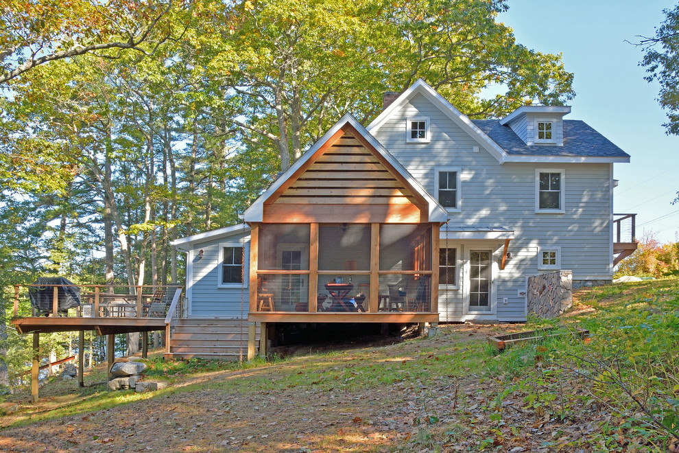 This is an example of a gey nautical two floor house exterior in Portland Maine with wood cladding and a pitched roof.