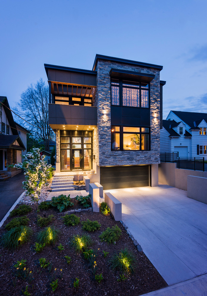 Идея дизайна: двухэтажный дом в современном стиле с облицовкой из камня и плоской крышей