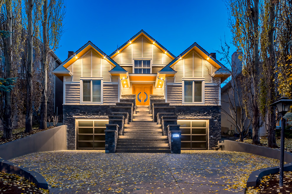 This is an example of an expansive and beige traditional two floor detached house in Calgary with concrete fibreboard cladding.