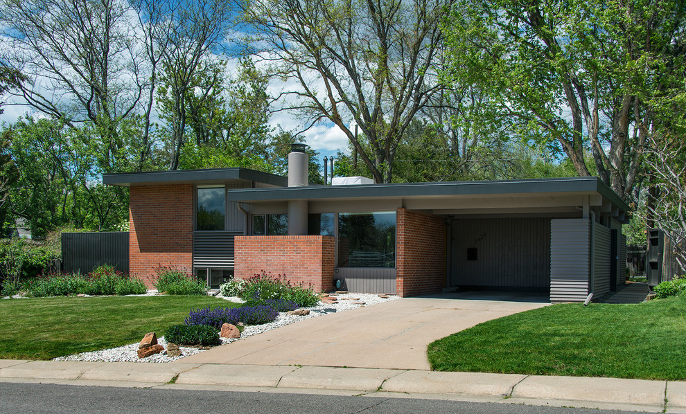 Retro split-level detached house in Denver with wood cladding and a flat roof.