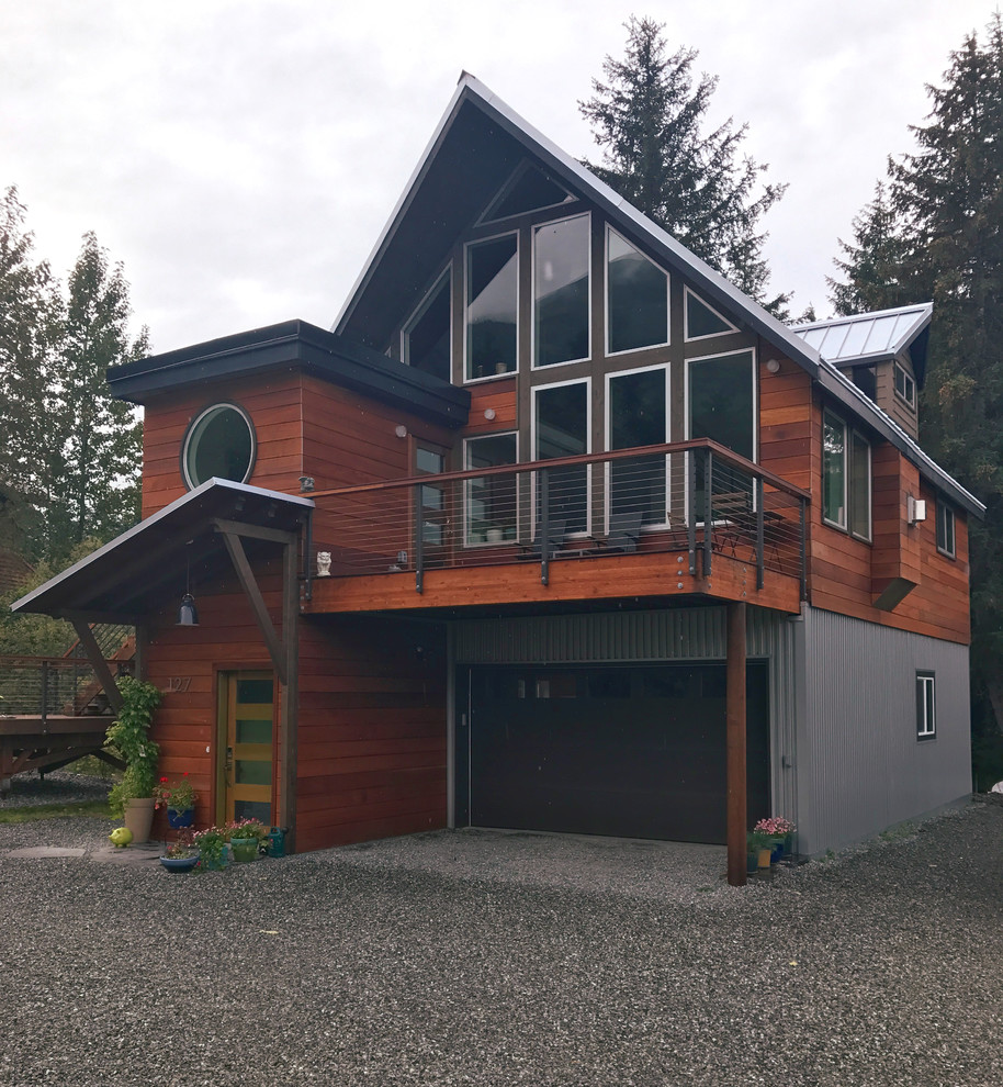 Mid-sized mountain style red two-story wood house exterior photo in Other with a shingle roof