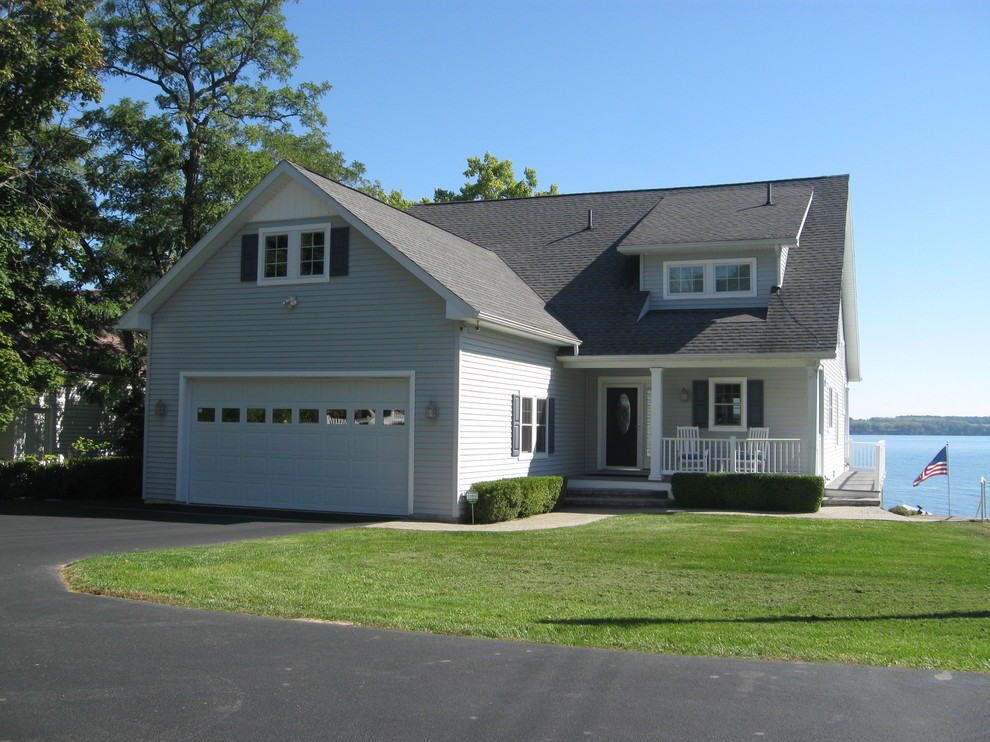 Photo of a medium sized and gey beach style two floor house exterior in New York with vinyl cladding and a pitched roof.
