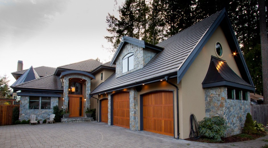 Inspiration for a huge timeless beige two-story stucco exterior home remodel in Vancouver