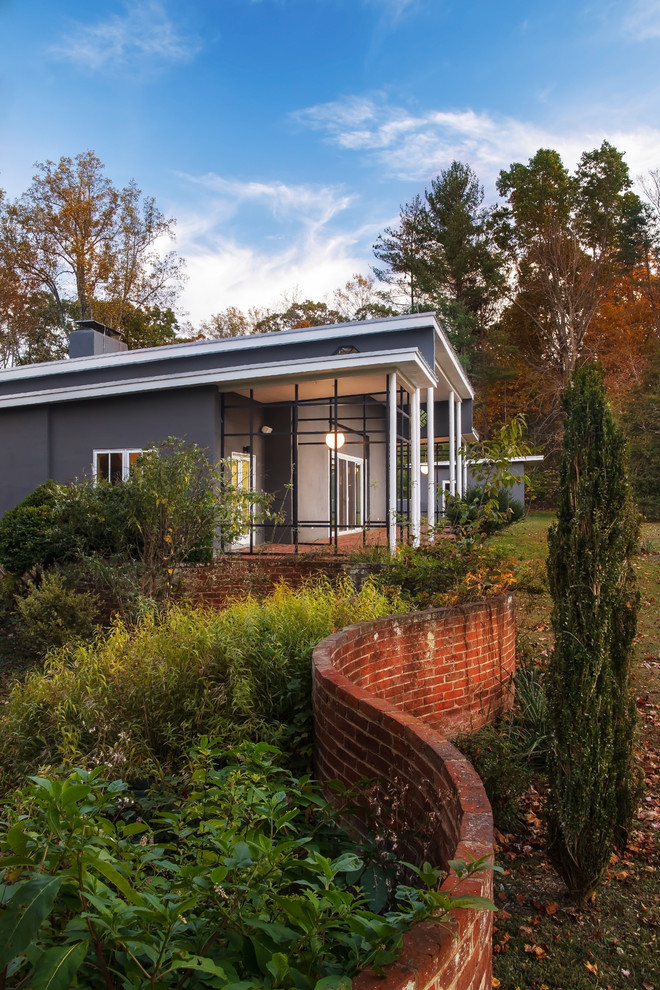 Large and gey midcentury bungalow render house exterior in DC Metro with a lean-to roof.