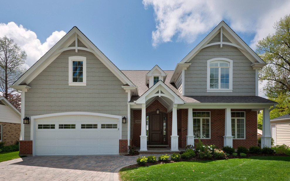 Traditional two floor house exterior in Chicago with mixed cladding and a pitched roof.