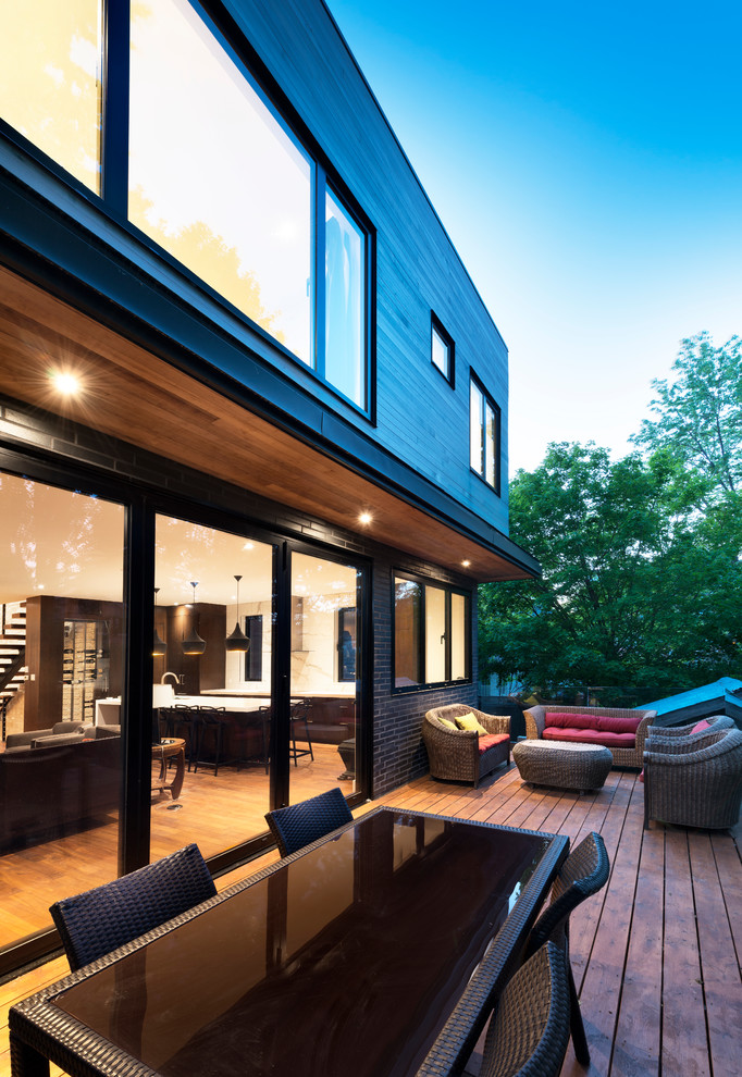 Trendy black three-story wood exterior home photo in Ottawa